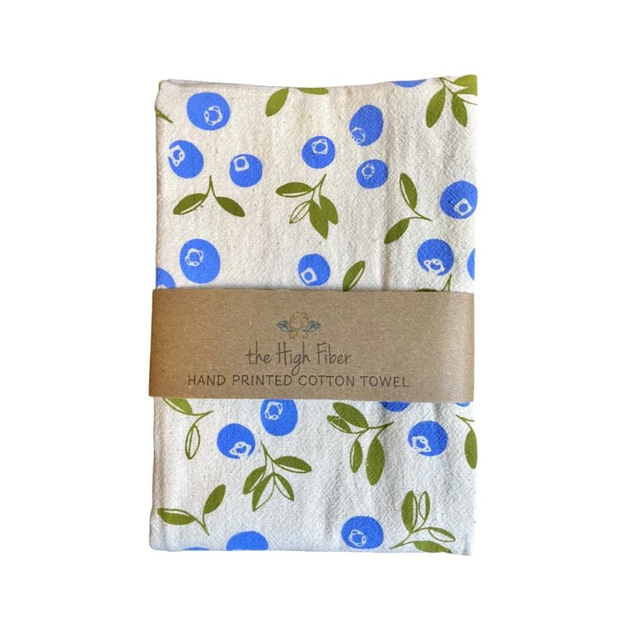 Hand-printed cotton towel with blue and green floral pattern, wrapped with a brown label on a white background.