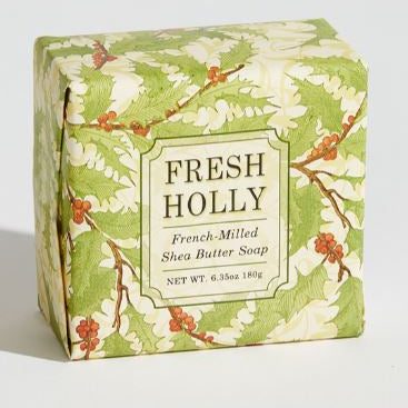 A bar of Fresh Holly French-milled shea butter soap, wrapped in paper with a floral pattern on the cover.