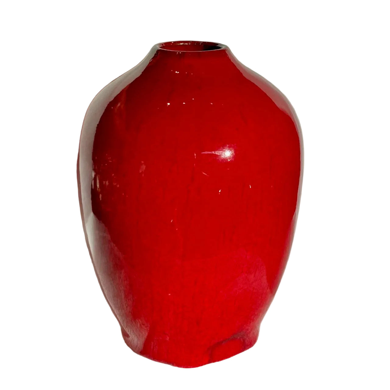 Red ceramic vase on a white textured surface