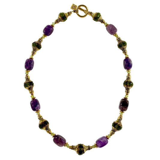 Necklace with purple and green beads on a white background