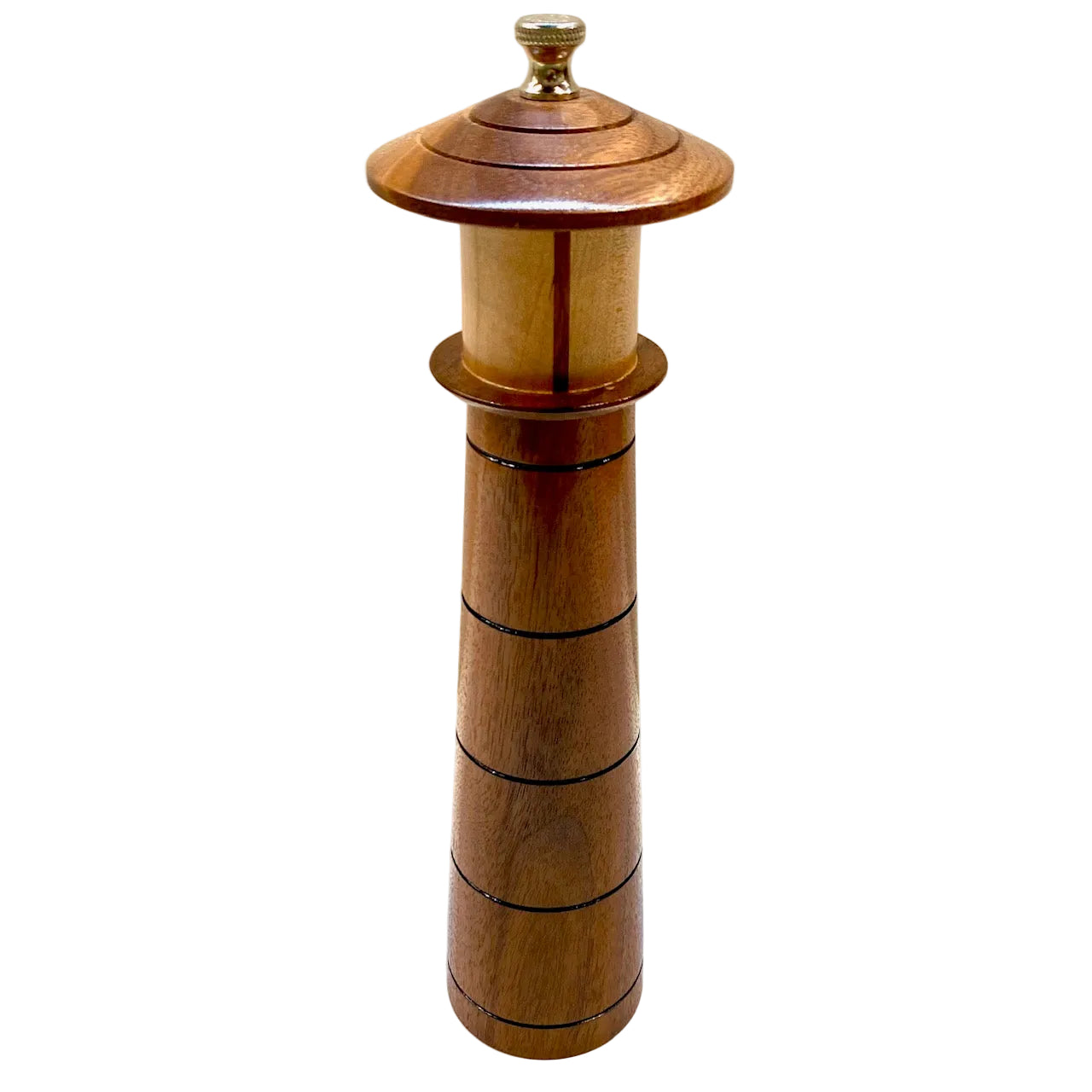 A wooden lighthouse-shaped pepper grinder with a domed top and metallic knob, photographed against a plain light background.