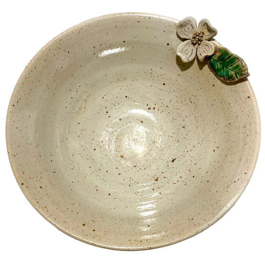 Ceramic bowl with a decorative flower on a white background