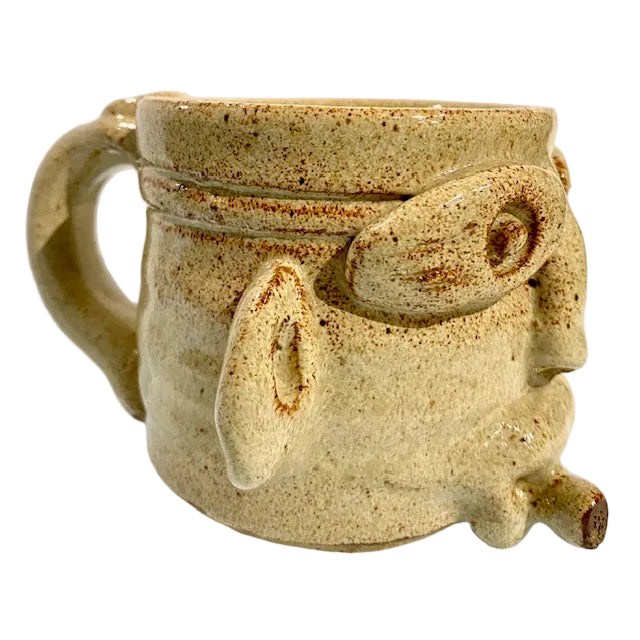 Ceramic mug with a face design on a white background
