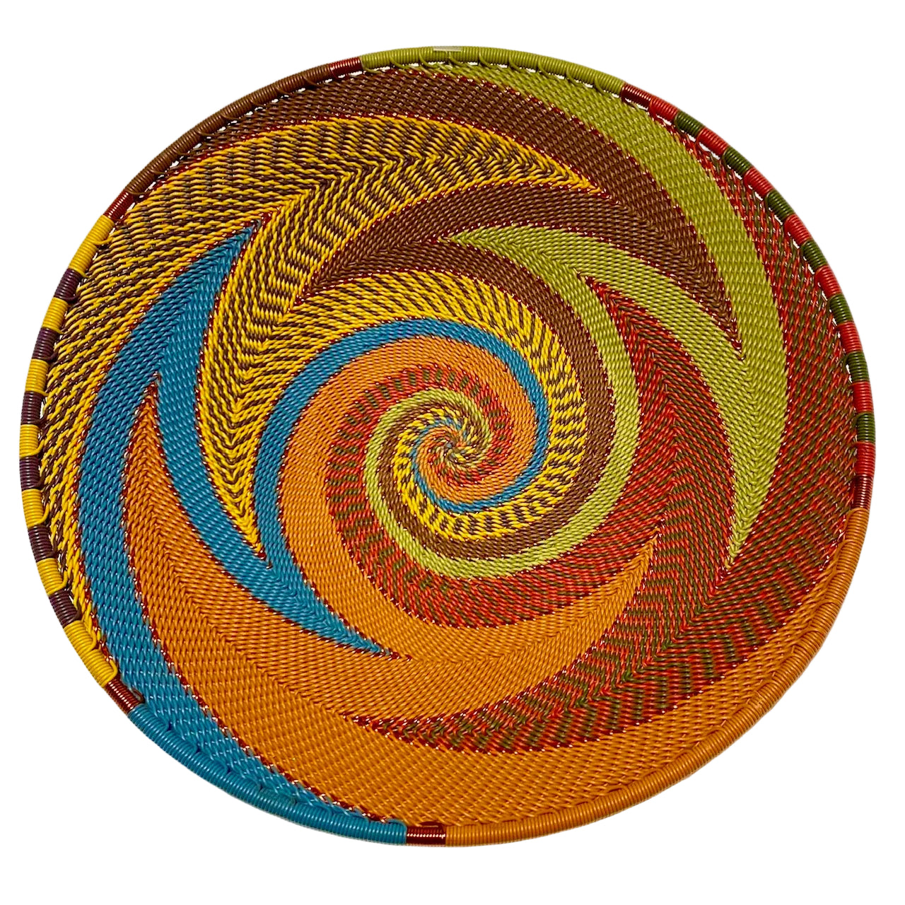 Colorful woven plate with a spiral pattern on a white background