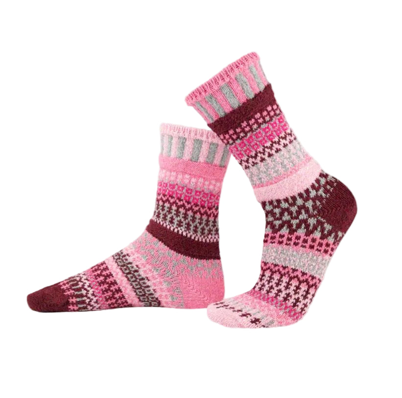 Pair of pink and maroon patterned socks on a light gray background