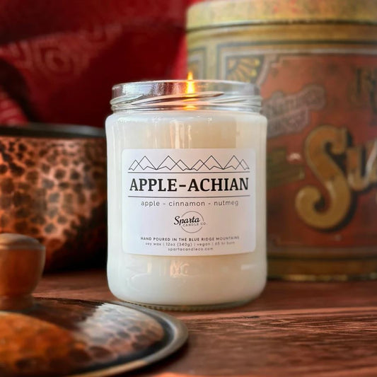 Candle labeled 'Apple-Achian' with a decorative background