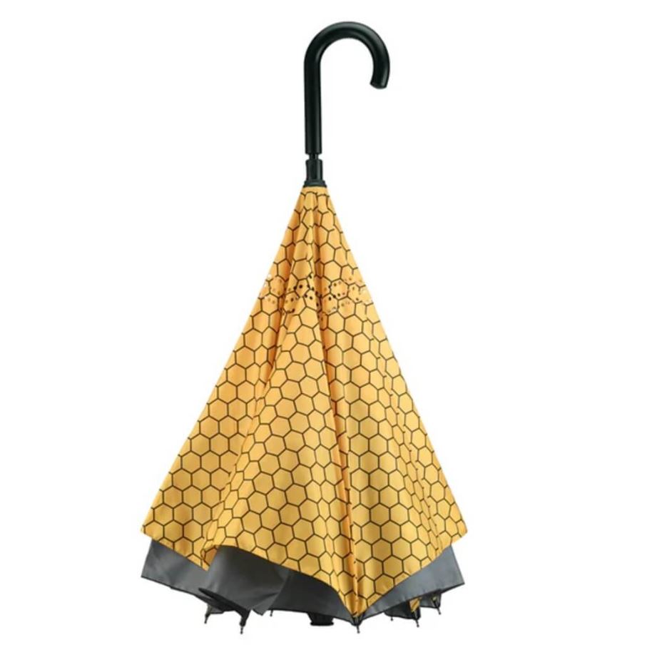 Yellow umbrella with black handle and trim on a white background