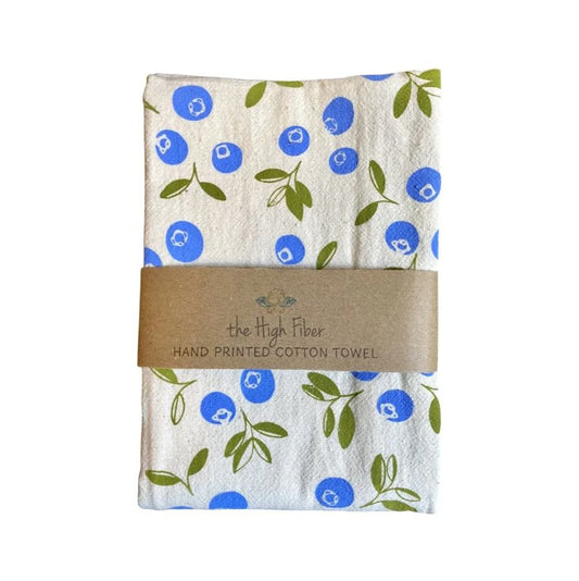 Hand-printed cotton towel with blue and green floral pattern, wrapped with a brown label on a white background.