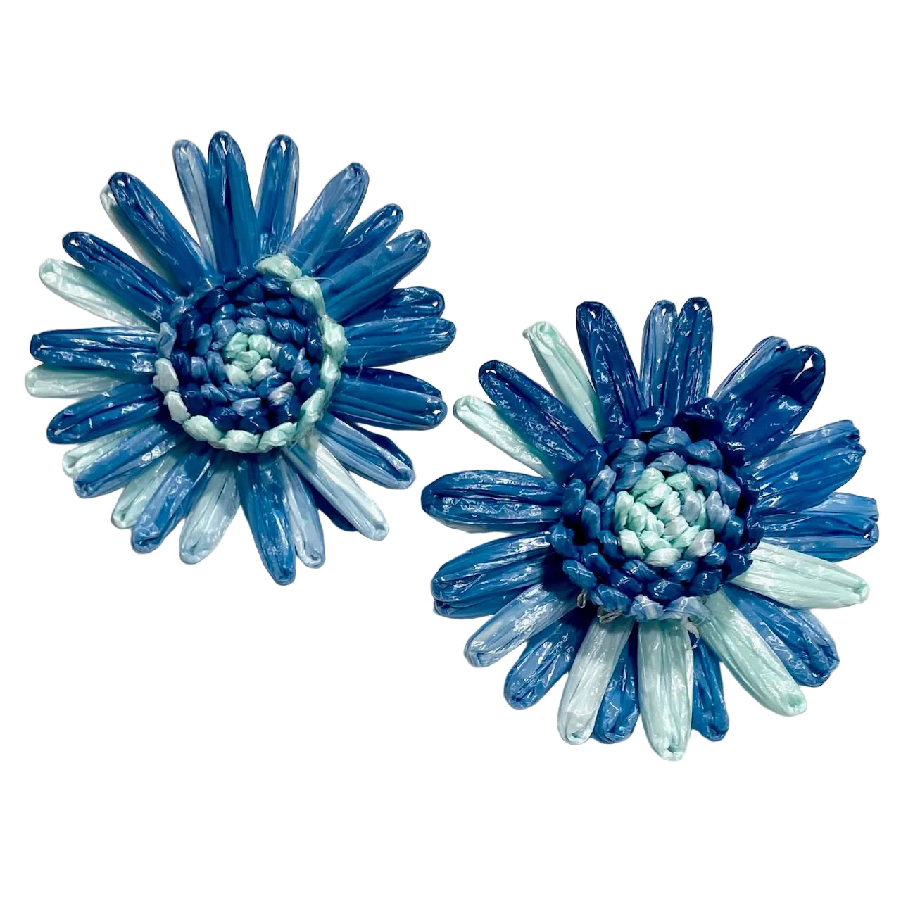 Blue and light blue flower-shaped earrings on a white background