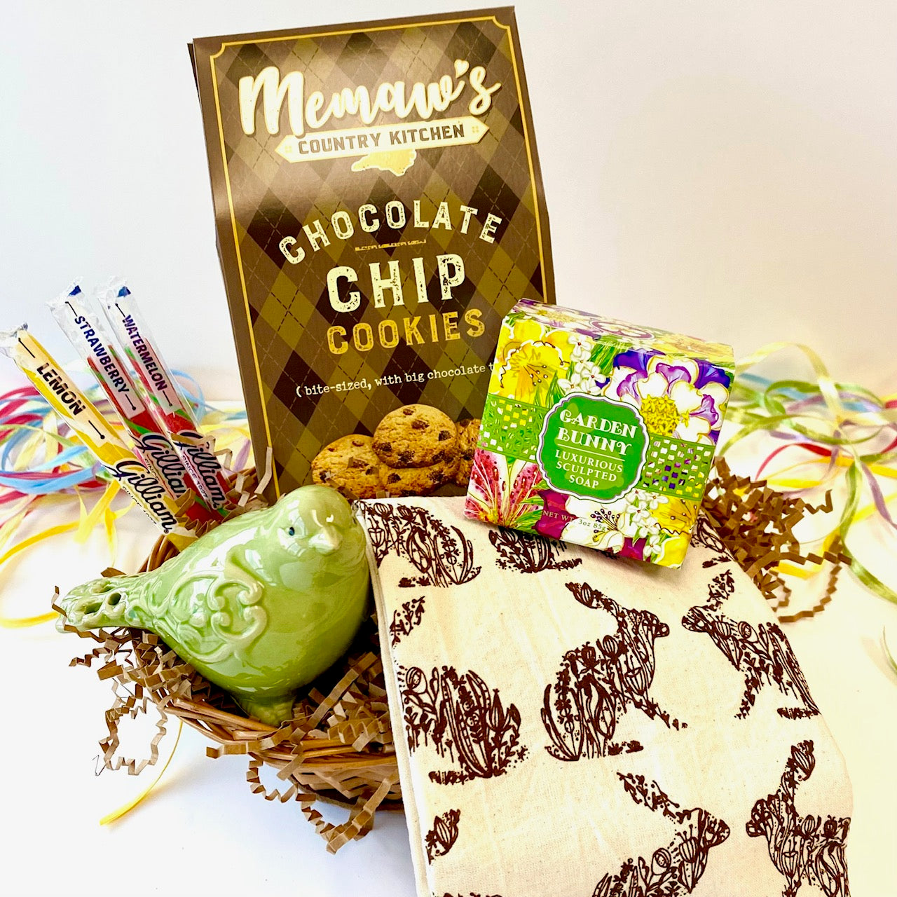 Gift basket with cookies, soap, and stationery items on a white background