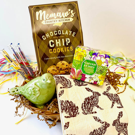 Gift basket with cookies, soap, and stationery items on a white background