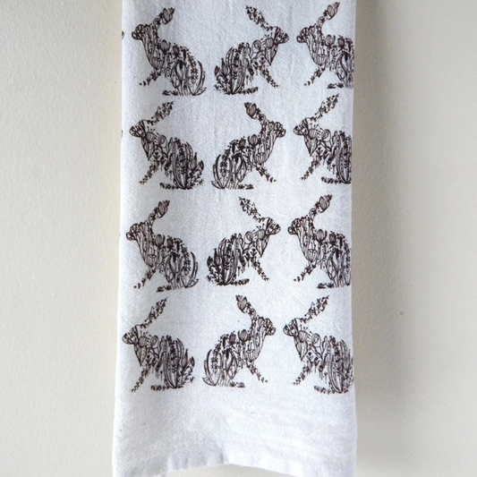 White towel with black rabbit pattern on a white background