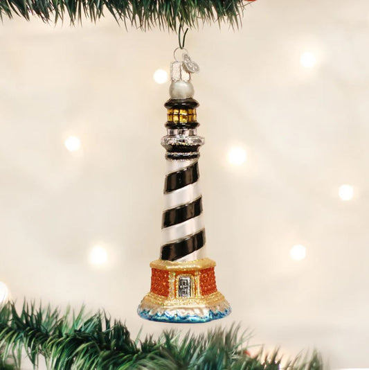 Decorative lighthouse ornament on a Christmas tree with a light background