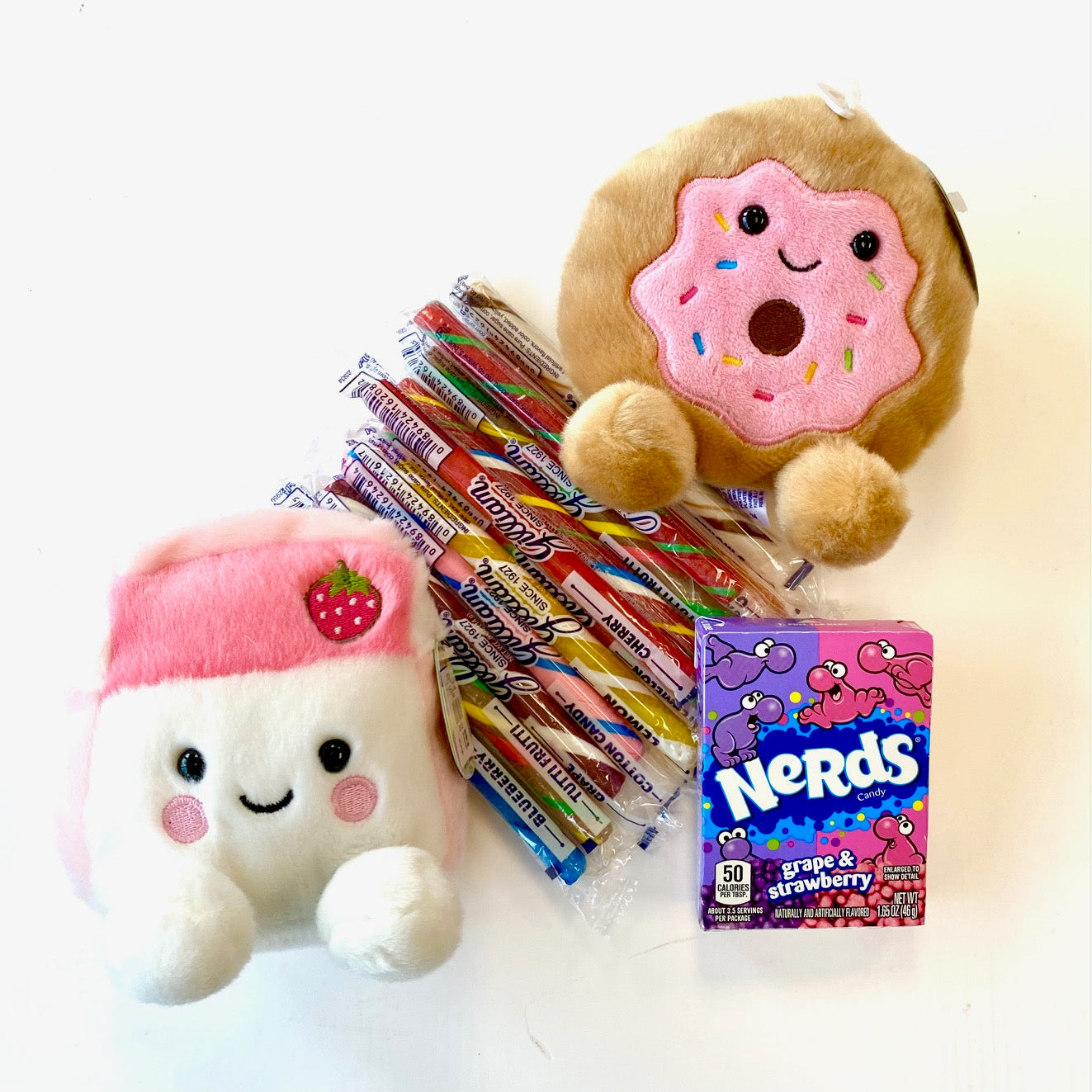 Plush toys and candy on a white background