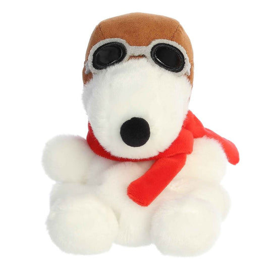Plush dog toy with a brown hat and red scarf on a white background