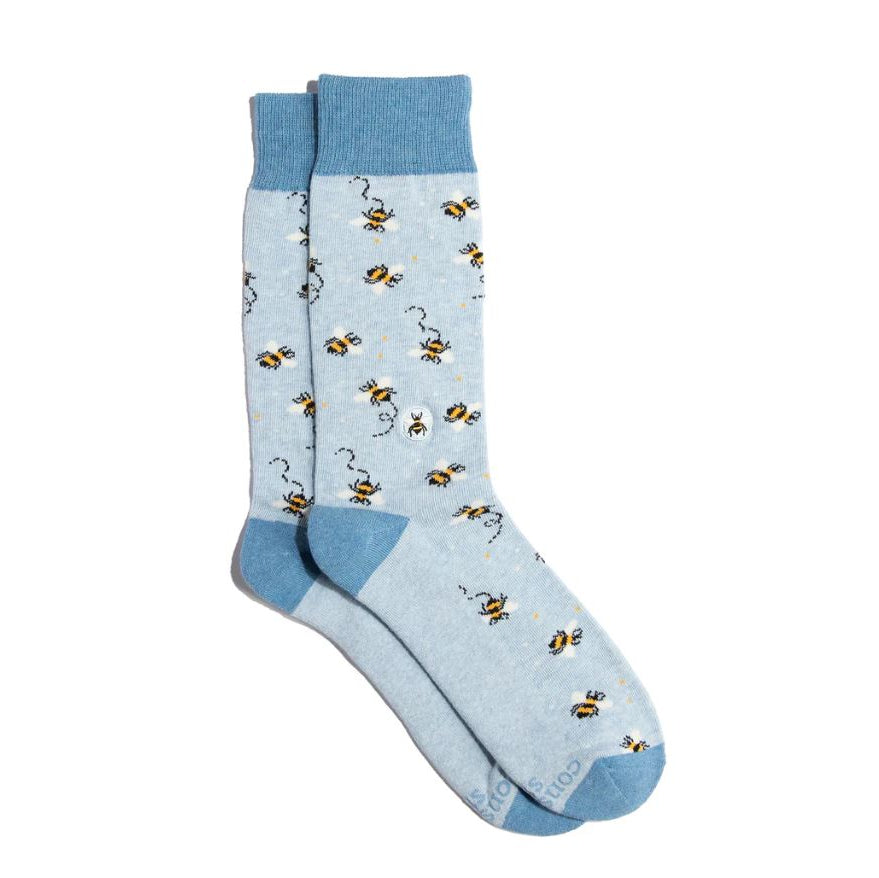 Light blue socks with bee pattern on a white background